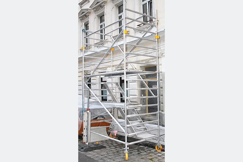 An aluminium scaffold tower with platforms, ladder and castors.